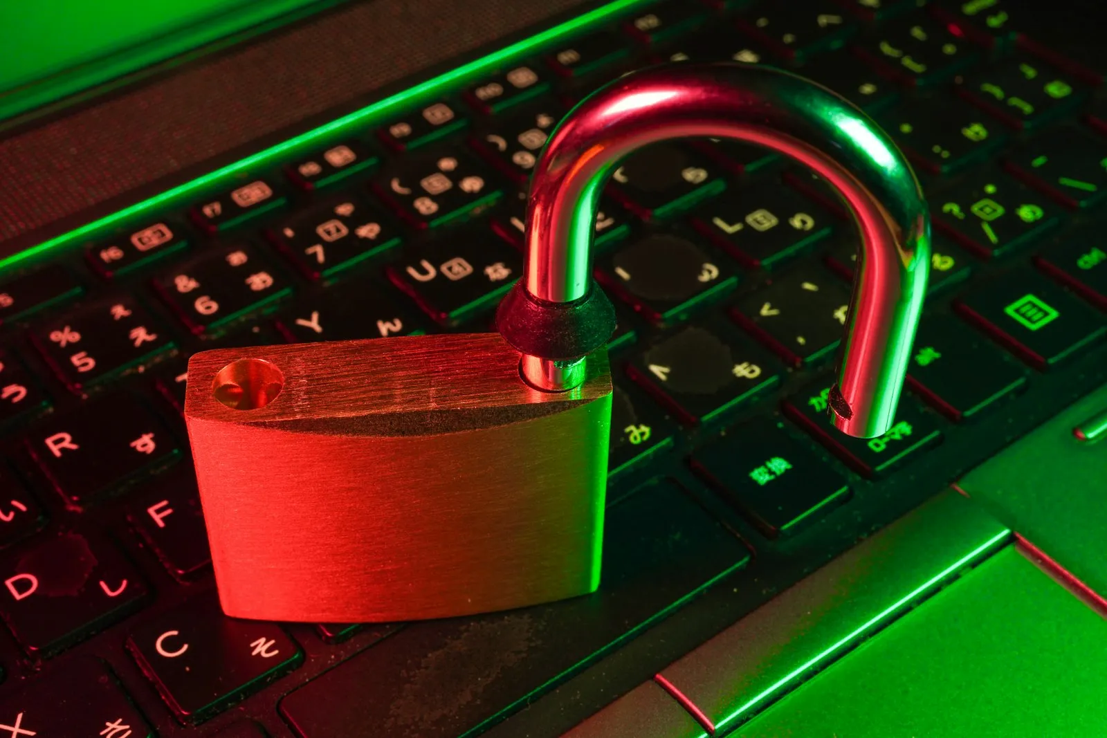 A red padlock lying on a black computer keyboard