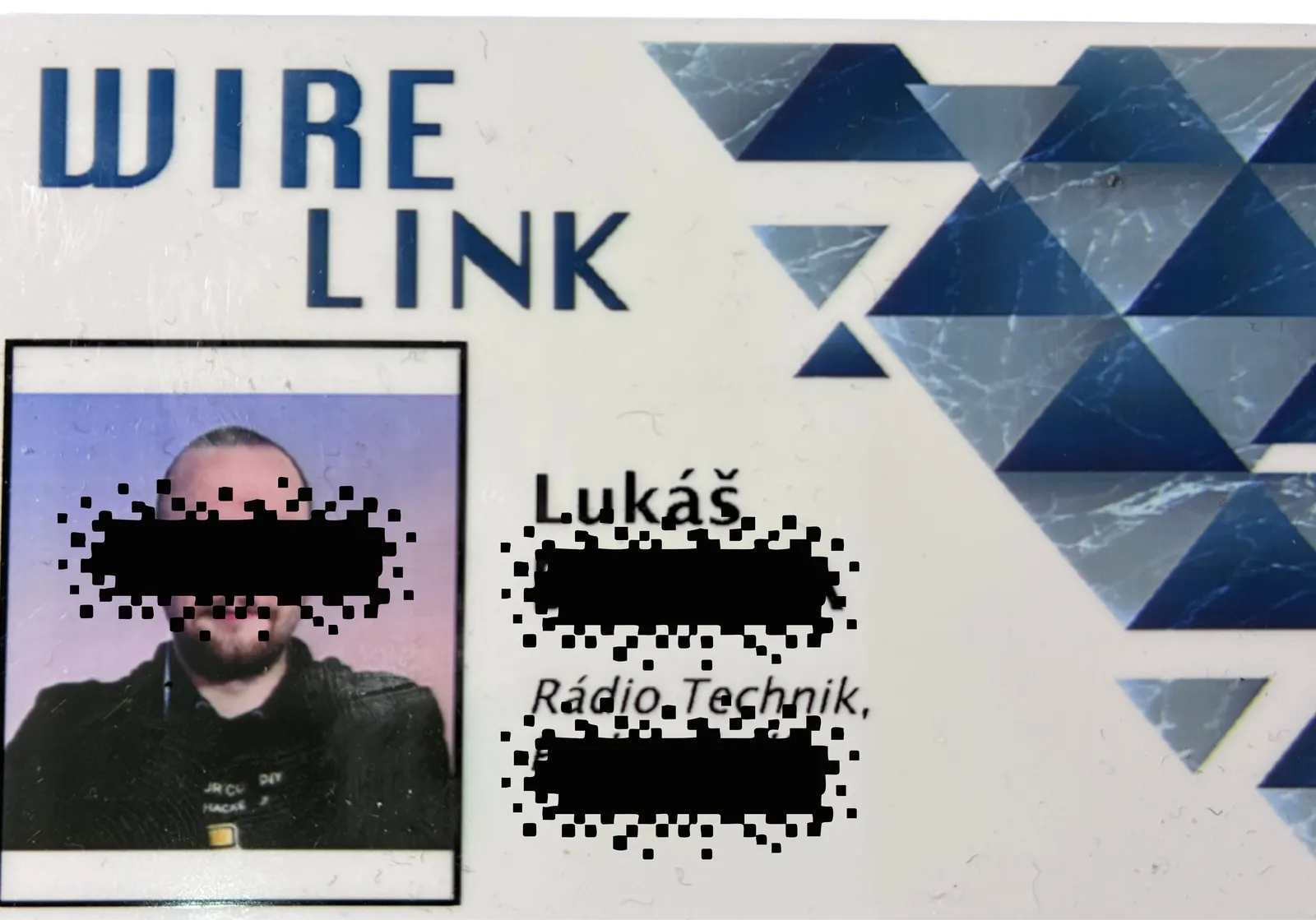 Laminated ID badge branded WIRE LINK, showing a photo, the first name Lukáš and the job title Rádio Technik, with personal details blacked out